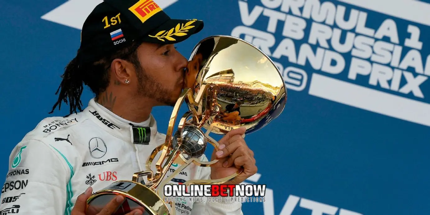 Lewis Hamilton kissing the golden trophy